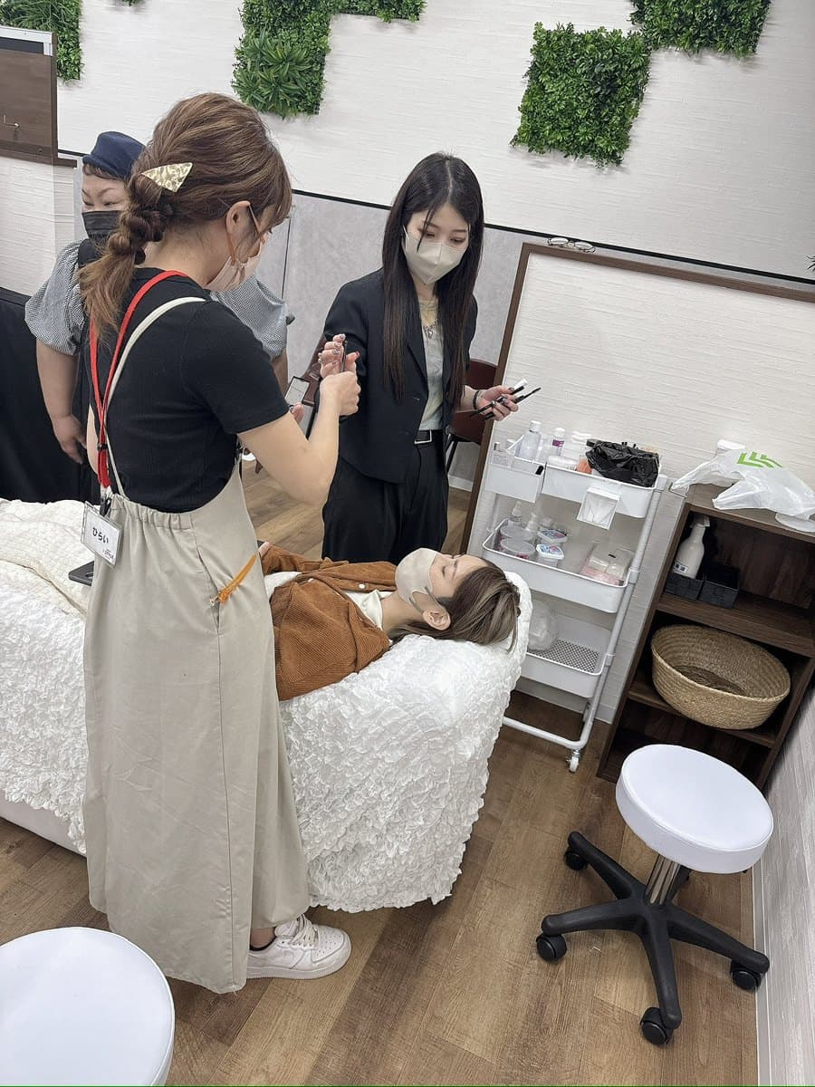 KATE stage LASHの研修で施術について話し合うスタッフ